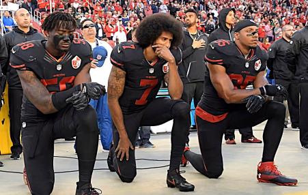 Colin Kaepernick and two teammates taking a knee before a 49ers game
