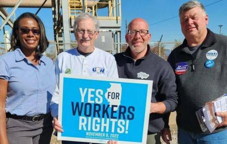 4 men holding a sign that reads YES TO WORKERS RIGHTS