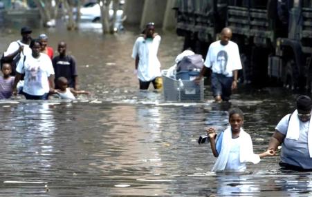 Hurricane Katrina victims in New Orleans wading through waist-deep floodwater