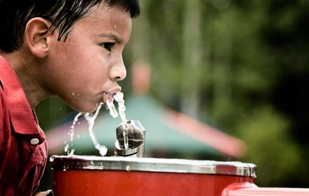 Latinx child drinking water