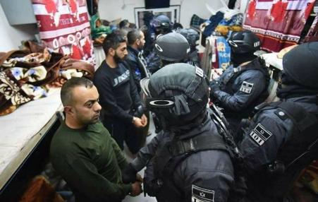 Palestinian prisoners in their cell with Israeli forces
