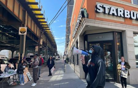 People picketing outside Starbucks with signs and bullhorns