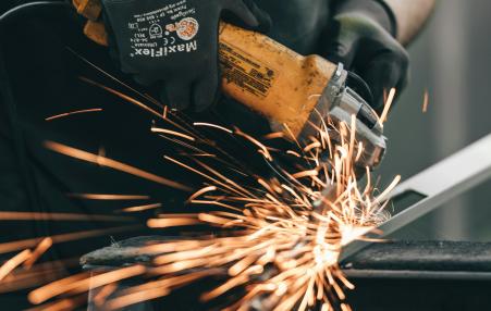 fire shooting out as a welder welds.